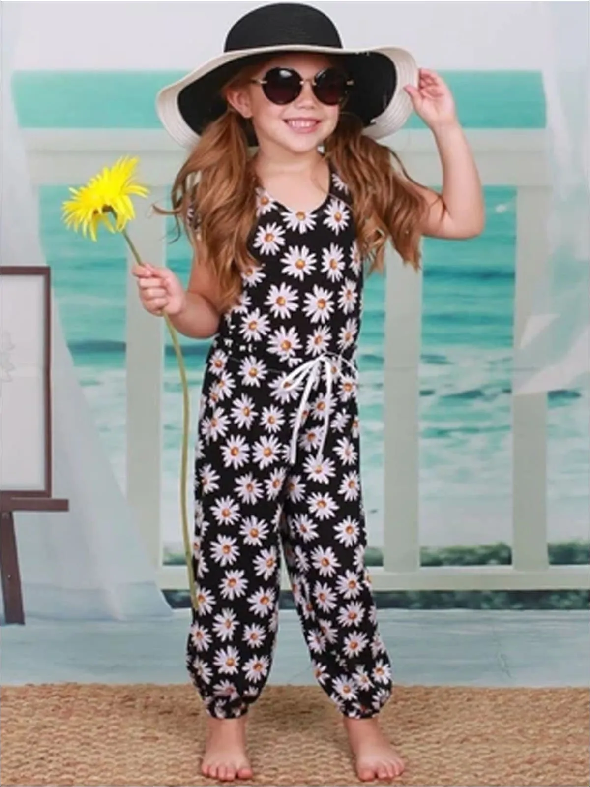 Girls Black Daisy Print Pom Pom Cap Sleeve Ribbon Bow Jumpsuit